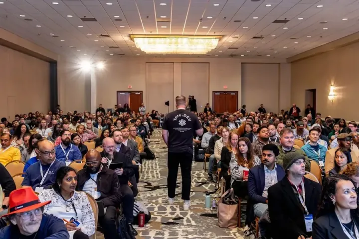 Taylor Desseyn of Torc.dev walking out into the middle of a full ballroom to talk about the AI jobs of the future