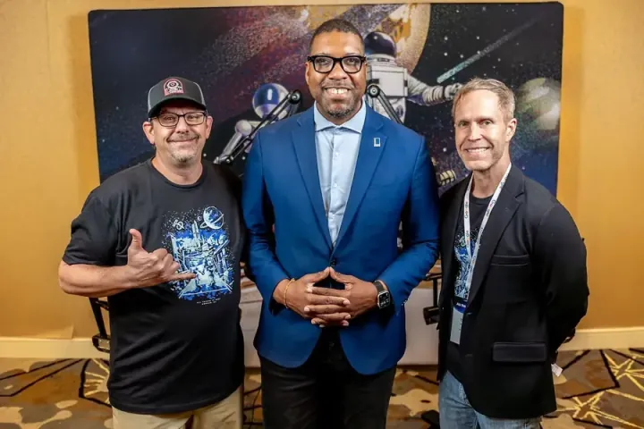 Durham Mayor Leo Williams in the middle, with Jason Hibbets on the left and All Things AI co-founder Todd Lewis on the right, in front of the astronaut backdrop