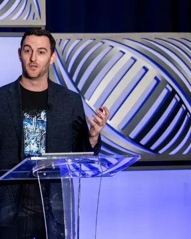 Ben Heller, Field CTO at Microsoft, gesturing with both hands at the keynote podium