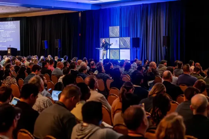 Luis Lastras of IBM on the keynote stage, a packed ballroom seen from the side