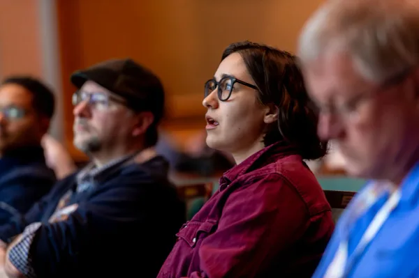 Close-up of an attendee looking toward the stage at All Things AI 2026