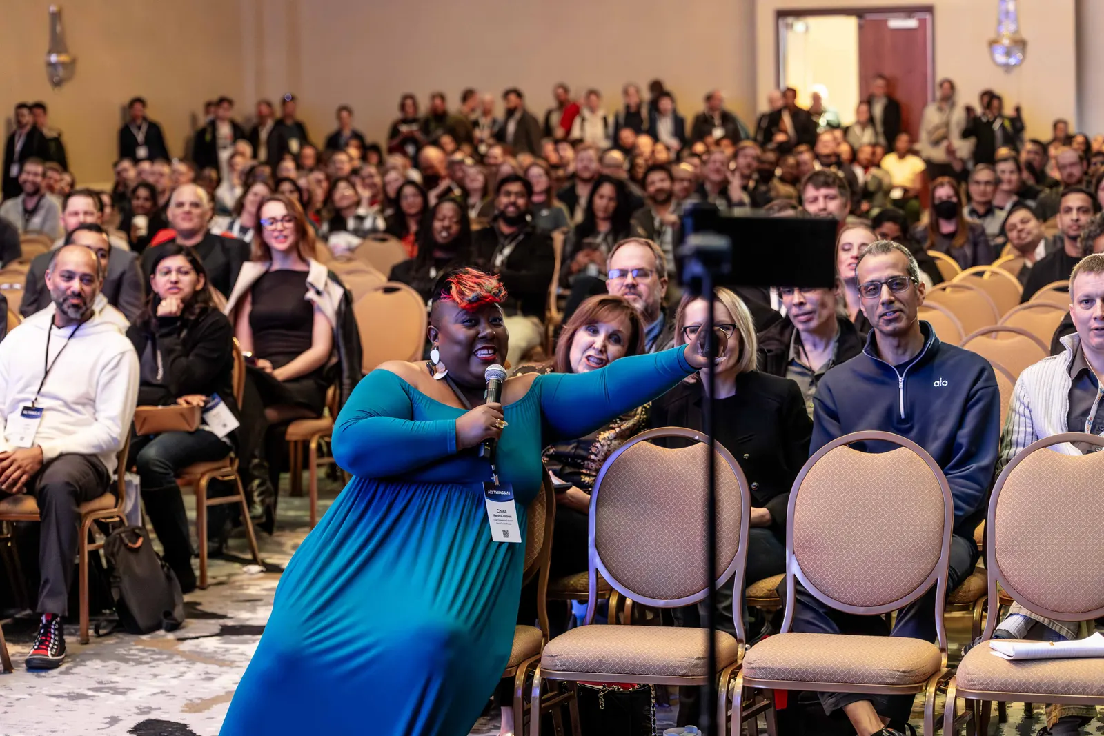 A smiling speaker taking a group selfie with the conference audience at All Things AI 2026