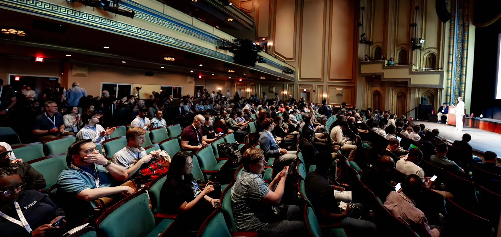 A wide view of the Carolina Theatre audience, ornate balcony, and stage during All Things AI 2026