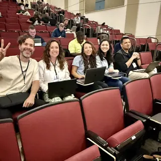 A row of people with laptops at Build an Agent Day in Charlotte